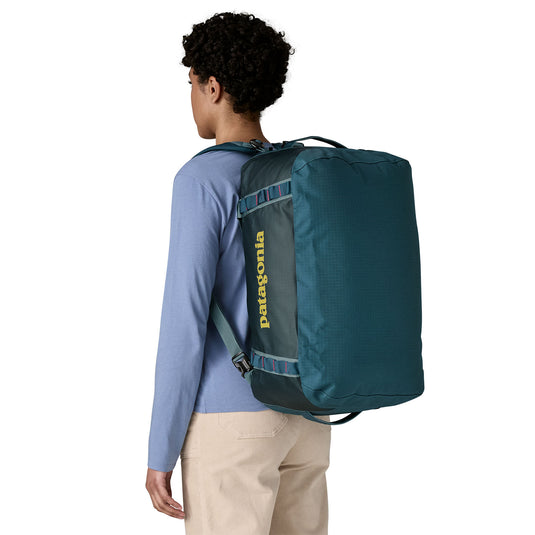 Black Hole Duffel 40L in Tidal Teal w/Luminous Pink on models back