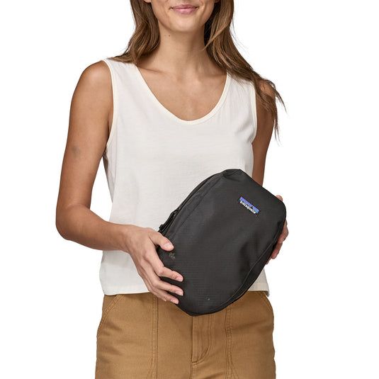 Patagonia Black Hole Cube 6L in black held by model