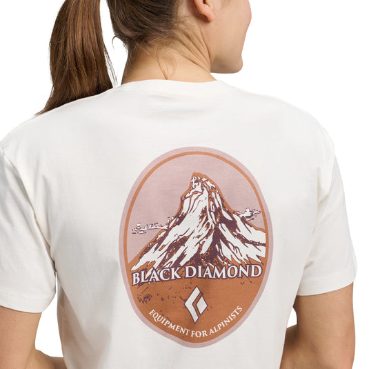 Black Diamond Women's Heritage Badge Short Sleeve Tee in offwhite - with large mountain design on back worn on model facing away