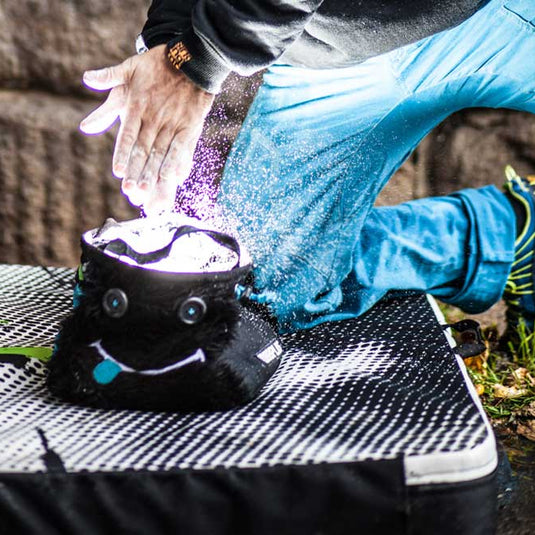 8B+ Hector chalk bucket in black fur design outside with climber chalking up