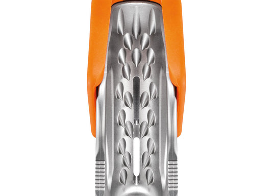 Close up of angled teeth inside orange Petzl Tibloc