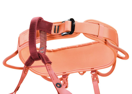 A corax LT woman harness by Petzl in orange design. With 4 gear loops and fixed leg loops. close up of the belay loop and waist belt