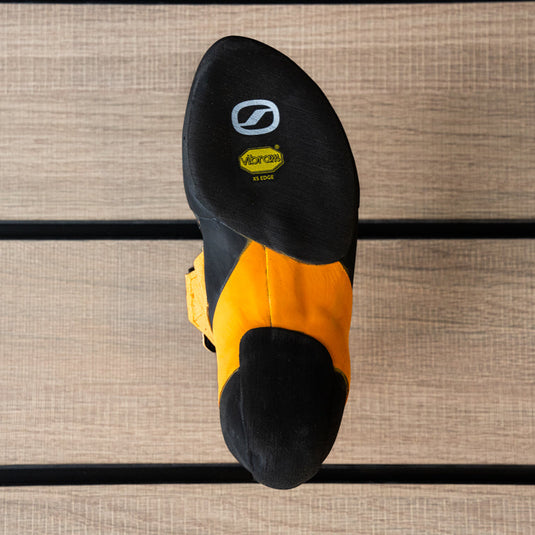 The sole of a climbing shoe, Scarpa Instinct VS, showing Vibram rubber logo and split sole