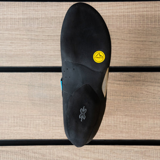 The sole of a climbing shoe, La Sportiva Tarantula Boulder womens, showing Friction RS Black rubber logo