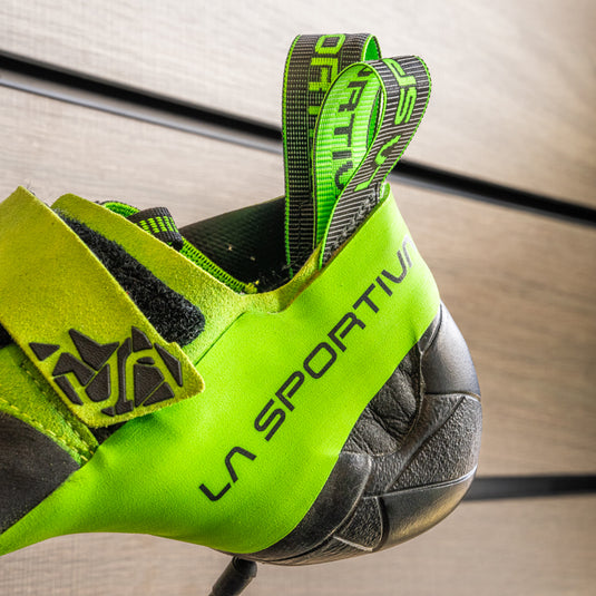 A close up of La Sportiva Skwama vegan heel, resting on black hook against metallic background.