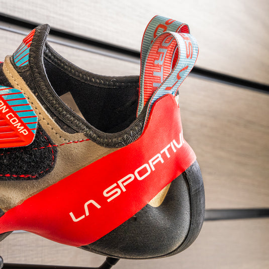 A close up of La Sportiva solution comp women heel, resting on black hook against metallic background.