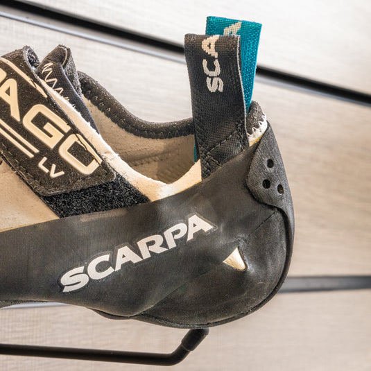 A close up of Scarpa Drago LV textured heel, resting on black hook against metallic background.