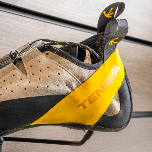 A close up of Tenaya Tarifa heel, resting on black hook against metallic background.