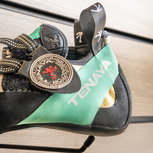 A close up of Tenaya Oasi LV heel, resting on black hook against metallic background.