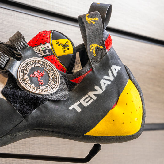 A close up of Tenaya Iati heel, resting on black hook against metallic background.