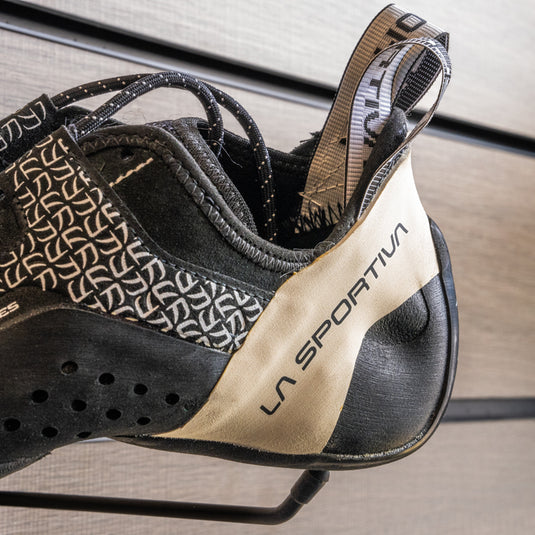 A close up of La Sportiva katana lace women heel, resting on black hook against metallic background.