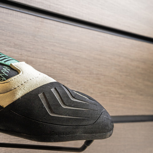 A close up Scarpa Vapour S Women toe box, resting on black wall hook against metallic background.