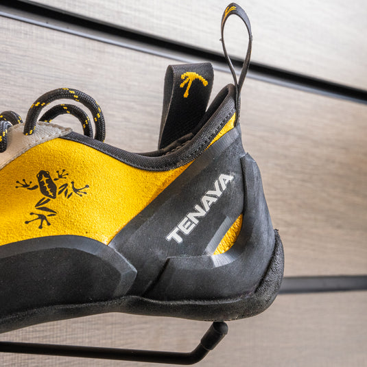 A close up of Tenaya Masai heel, resting on black hook against metallic background.