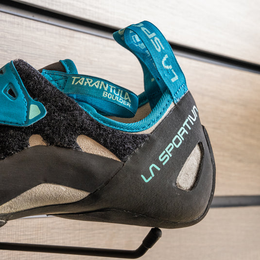 A close up of La Sportiva Tarantula Boulder Womens Heel, resting on black hook against metallic background.
