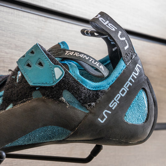 A close up of La Sportiva Tarantula womens heel, resting on black hook against metallic background.