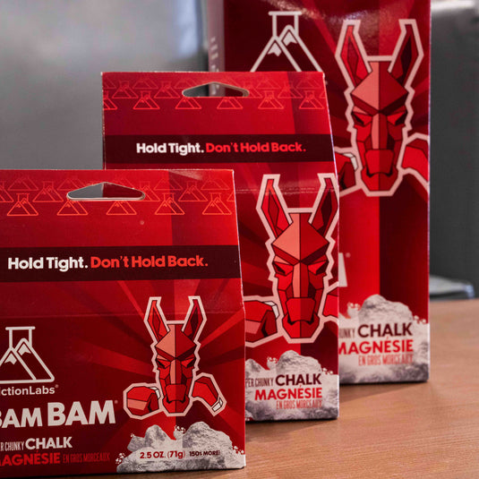 Three red packages of Friction Labs Chalk - BAM BAM - featuring a geometric horse logo with the tag line "Hold Tight. Don't Hold Back"