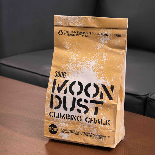 300g moon dust climbing chalk in a brown paper package displayed on wooden surface.
