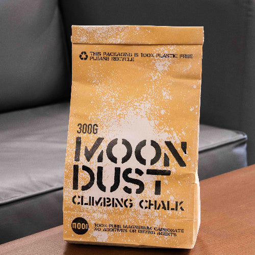 300g moon dust climbing chalk in a brown paper package displayed on wooden surface.