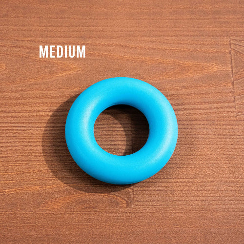 Blue Forearm trainer ring on wooden surface with the text medium in the background