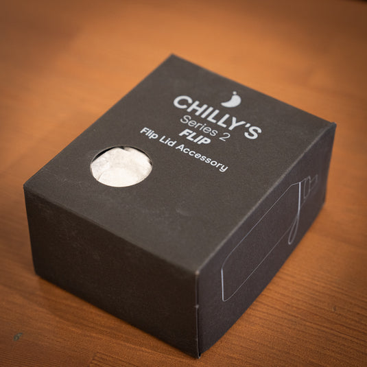 Chillys flip lid accessory packaged in a black box lay down with design on the side of the packaging.