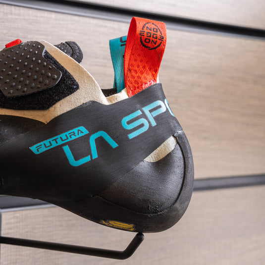 A close up of La Sportiva Futura heel, resting on black hook against metallic background.