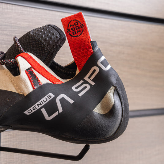 A close up of La Sportiva Genius heel, resting on black hook against metallic background.