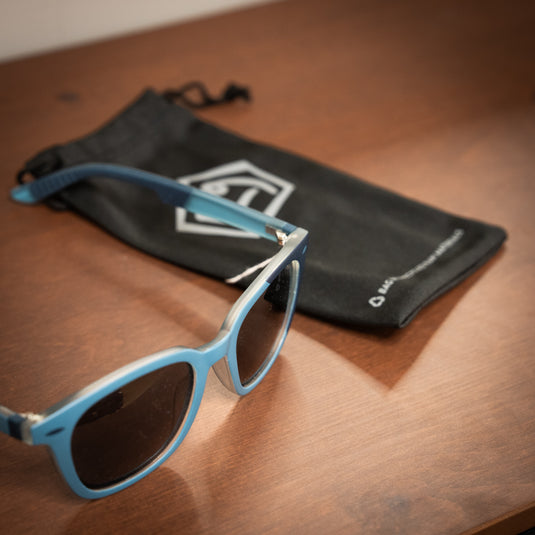 E9 claude sunglasses in Agave with black sunglasses bag in background