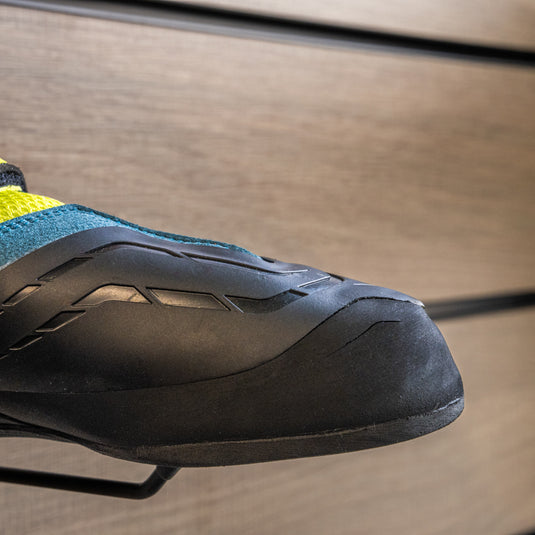 A close up Scarpa Origin VS toe box, resting on black wall hook against metallic background.