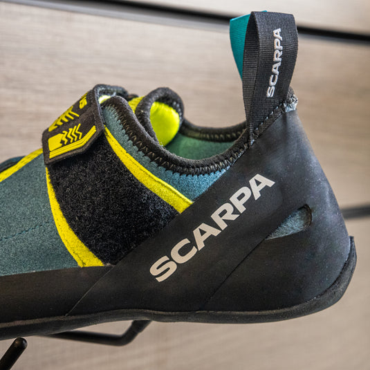 A close up of Scarpa Origin VS, resting on black hook against metallic background.