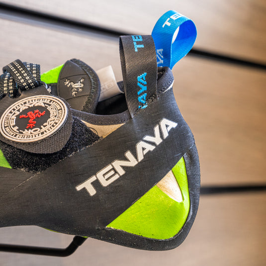 A close up of Tenaya Mundaka heel, resting on black hook against metallic background.