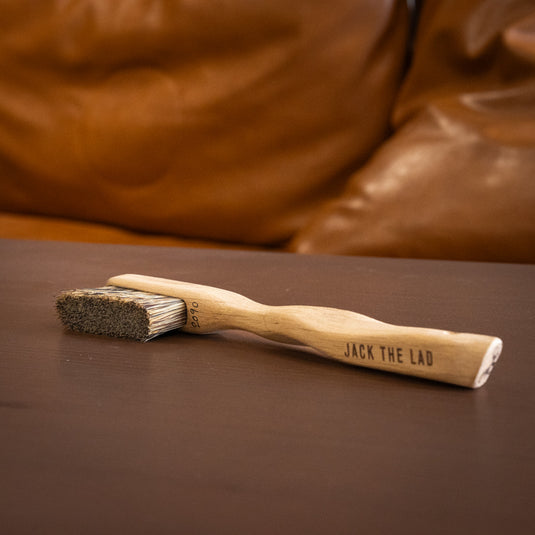 One Jack the Lad Climbing brush resting on wooden surface. Jack the Lad engraved on the handle and brush ID number 2090