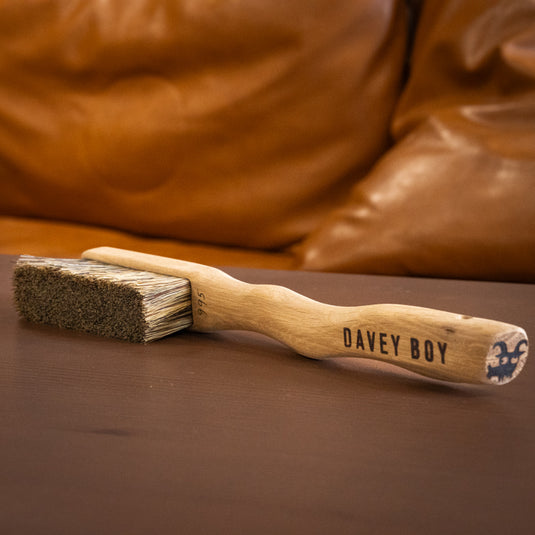 One Davey Boy Silly Goat brush resting on wooden surface. Davey Boy engraved on the handle and brush ID number 995