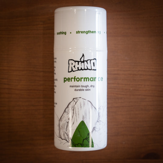 Pump bottle of Rhino Skin Performance - maintain tough, dry durable skin. White and green design, displayed on wooden surface.