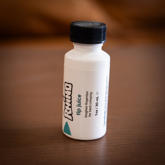 Small brush on container of Rhino tip juice - toughen fingertips for hard crimping on wooden surface