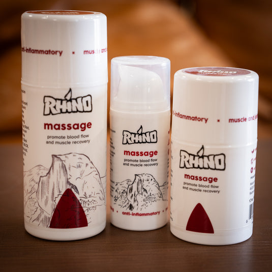 Three containers of Rhino Massage - promote blood flow and muscle recovery of varied sizes displayed on wooden surface