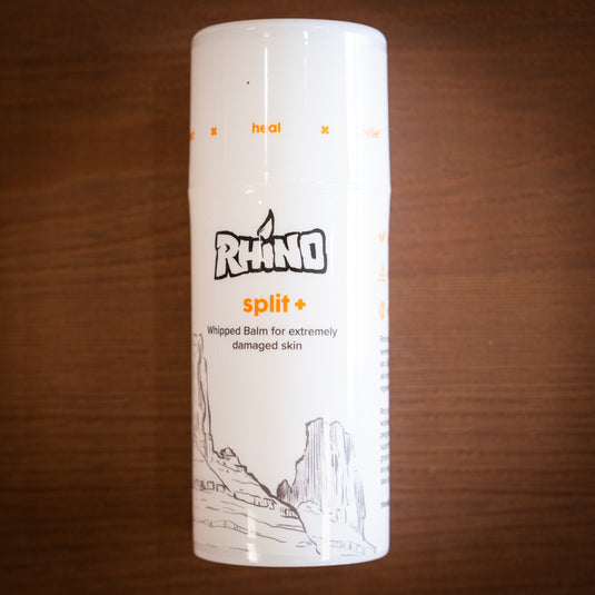 One bottle of Rhino split+ whipped balm for extremely damaged skin, laid on a wooden surface.