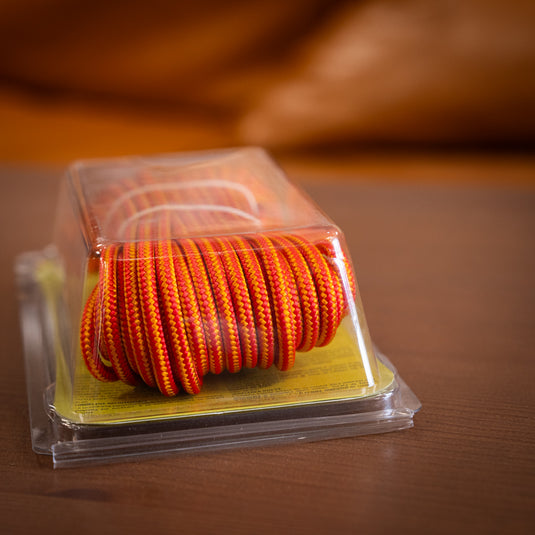 Tendon Cord in 4mm/10m in orange - rested on wooden surface