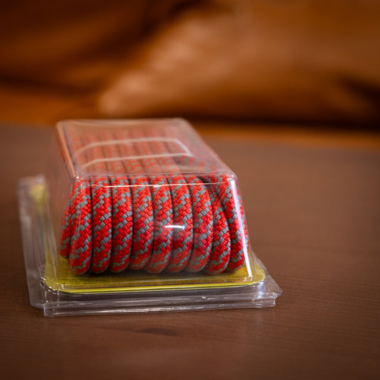 5m of 7mm premium Tendon Cord in red laid on wooden surface