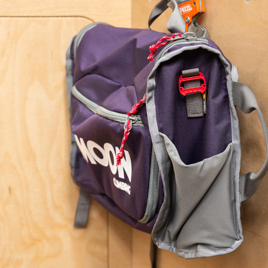 Moon Bouldering Bag - Blackberry in shoulder style showing side pocket for water bottles