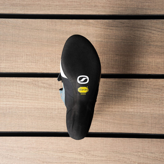 The sole of a climbing shoe, Scarpa Force womens, showing Vibram rubber logo