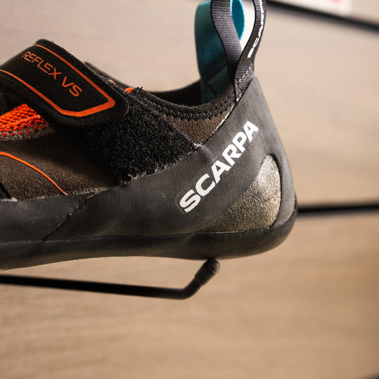 A close up of Scarpa Reflex VS heel, resting on black hook against metallic background.