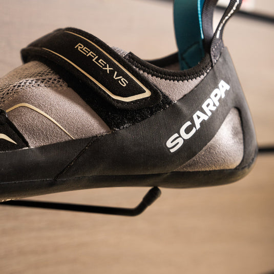 A close up of Scarpa Reflex WMN VS heel, resting on black hook against metallic background.