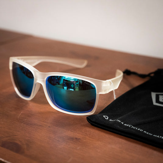 E9 Paul sunglasses in transparent frame on wooden surface