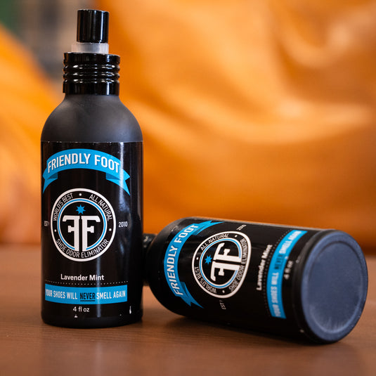 two friendly foot sprays. in black spray bottle with blue and white design