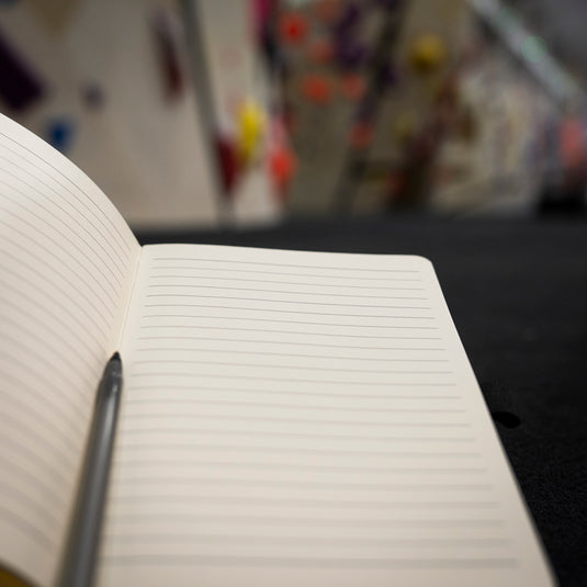 Opened Depot Climbing Printed Note Book showing lined pages at boudlering gym
