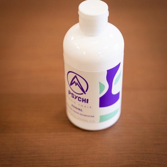 Side Profile of Psychi Liquid chalk, 250ml bottle with purple and green design.