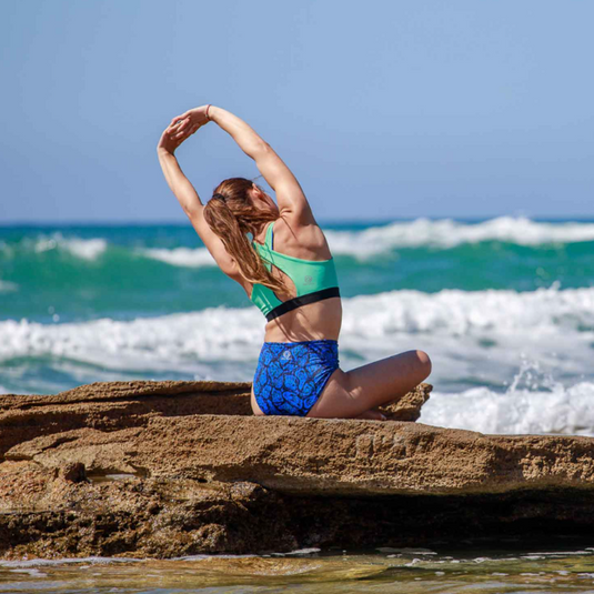3rd Rock Equinox Sports Bra in Geo Jaguar design, worn by model with reversed teal design