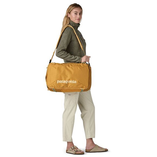Patagonia Black Hole Mini MLC in smoulder blue - carried by model in shoulder bag