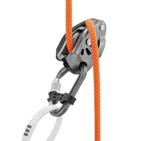 Petzl Attache Bar Screw Lock Carabiner attached to a belay loop of a harness with the bar on the carabiner. Also attached to the opposite end is a Petzl Neox Belay device with orange rope threaded through