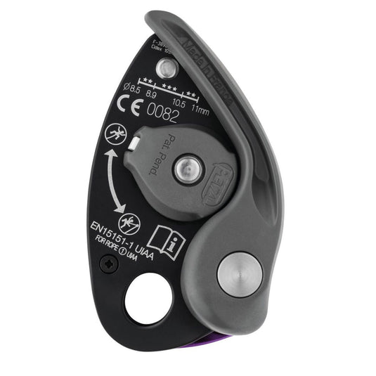 Back of a Petzl Gri Gri + showcasing safety information in white text